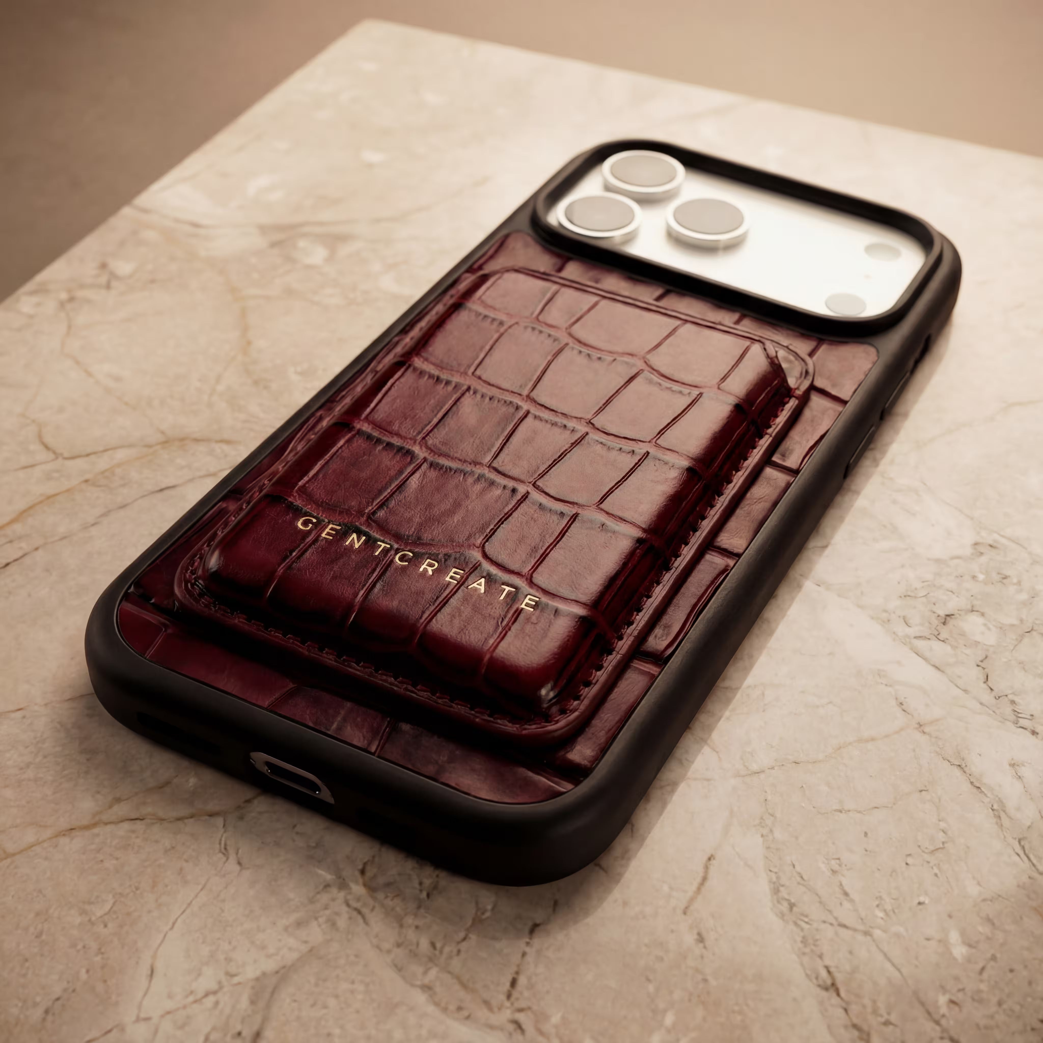 Close up of Magsafe Cardholder in burgundy color attached to an iPhone 17 Pro Max case with GENTCREATE logo